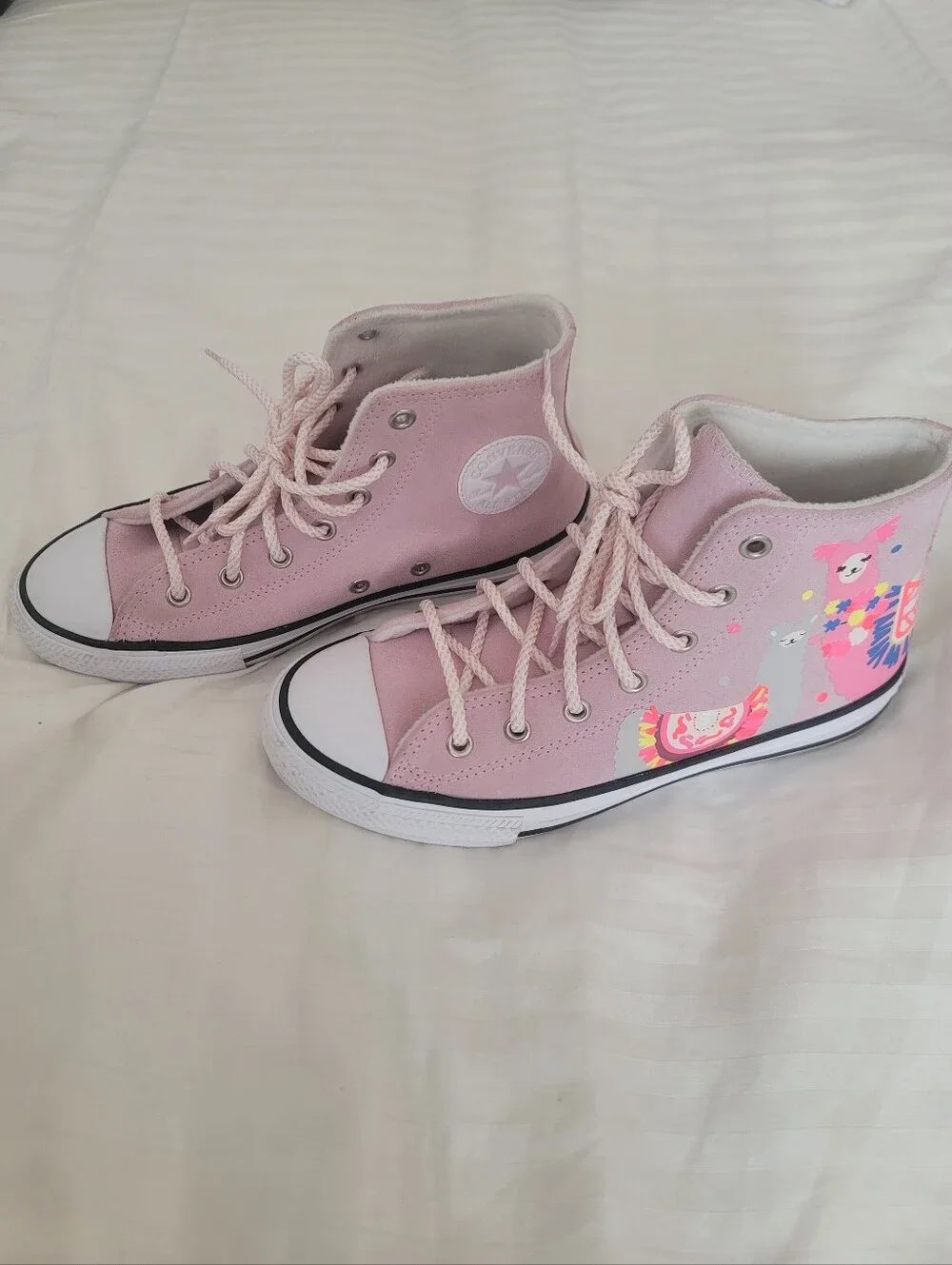Pink Converse Chuck Taylor All Star High sneakers feature a playful llama